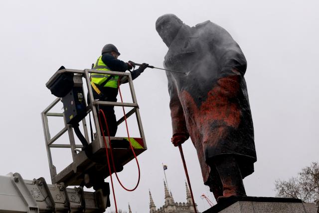 A worker pressure washes graffiti off of a statue of Britain’s former Prime Minister Winston Churchill in Parliament Square, in central London on February 27, 2026. A 38-year-old man has been arrested on suspicion of racially aggravated criminal damage after graffiti was sprayed on the statue of Winston Churchill, UK police said February 27.
The iconic statue of the wartime British Prime Minister in parliament square in central London "was graffitied with red paint" overnight, the Metropolitan Police said on X. (Photo by Brook Mitchell / AFP)