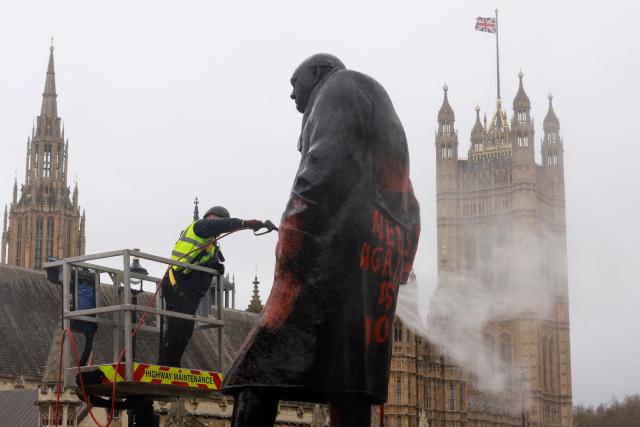A worker pressure washes graffiti off of a statue of Britain’s former Prime Minister Winston Churchill in Parliament Square, in central London on February 27, 2026. A 38-year-old man has been arrested on suspicion of racially aggravated criminal damage after graffiti was sprayed on the statue of Winston Churchill, UK police said February 27.
The iconic statue of the wartime British Prime Minister in parliament square in central London "was graffitied with red paint" overnight, the Metropolitan Police said on X. (Photo by Brook Mitchell / AFP)
