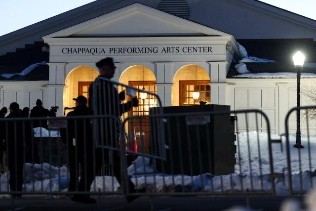 Police officers place barriers in position in front of The Chappaqua Performing Arts Center in Chappaqua, New York early February 27, 2026, ahead of the deposition of Bill Clinton. Former US President Bill Clinton is to testify behind closed doors before a congressional committee investigating the late convicted sex offender Jeffrey Epstein and his accomplice Ghislaine Maxwell. (Photo by CHARLY TRIBALLEAU / AFP)