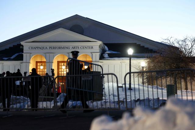 Police officers place barriers in position in front of The Chappaqua Performing Arts Center in Chappaqua, New York early February 27, 2026, ahead of the deposition of Bill Clinton. Former US President Bill Clinton is to testify behind closed doors before a congressional committee investigating the late convicted sex offender Jeffrey Epstein and his accomplice Ghislaine Maxwell. (Photo by CHARLY TRIBALLEAU / AFP)
