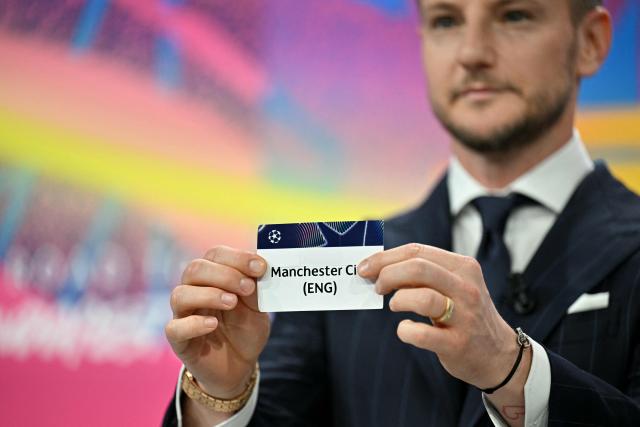 UEFA Foundation for Children ambassador and former Sevilla midfielder, Ivan Rakitic holds up the slip of Manchester City (ENG) during the 2025-2026 UEFA Champions League round of 16, quarter-final and semi-final draw at the House of European Football in Nyon, western Switzerland on February 27, 2026. (Photo by Harold CUNNINGHAM / AFP)
