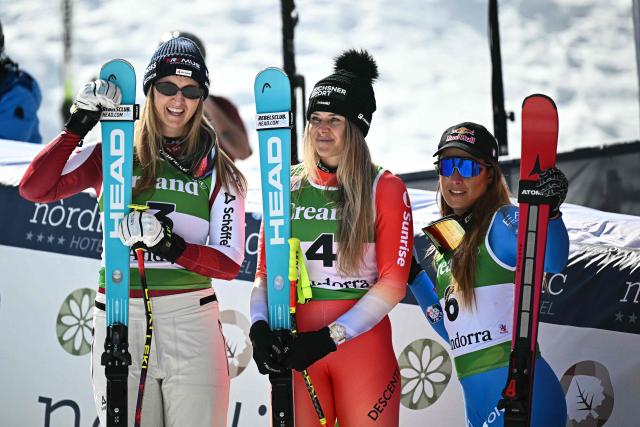 (From L) Second-placed Austria's Nina Ortlieb, first-placed Switzerland's Corinne Suter and third-placed Italy's Sofia Goggia celebrate after competing in the women's downhill race, part of the FIS Alpine Ski World Cup 2025-2026 in Soldeu, Andorra on February 26, 2026. (Photo by Lionel BONAVENTURE / AFP)
