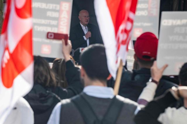 Berlin Mayor Kai Wegner addresses the crowd during a protest in front of German chemical giant BASF's European administrative headquarters (BASF Services Europe GmbH) in Berlin on February 27, 2026, over the company's plans to make budget cuts affecting the workforce. The chemical workers' union IGBCE has called to protest against plans to relocate large parts of the business from Berlin to India, asking to persuade the management to negotiate alternatives. (Photo by John MACDOUGALL / AFP)