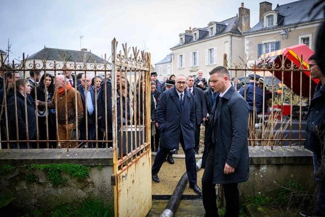 French Interior Minister Laurent Nunez walks next to a pump used to evacuate the water from a basement in Cheffes, outside Angers, during a visit focused on the consequences of the floods on February 27, 2026. (Photo by Loic VENANCE / AFP)
