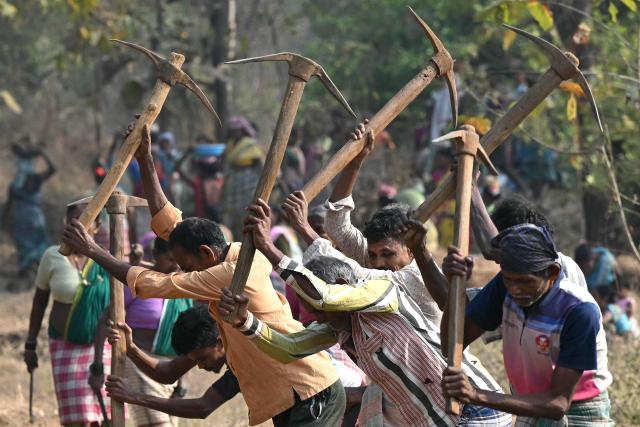This photograph taken on February 14, 2026 shows wage-labourers under Mahatma Gandhi National Rural Employment Guarantee Act (MGNREGA) toiling a dirt road at a road-construction site at Balapur Dolkarpada village in Maharashtra's Palghar district. India's economy grew at a faster pace than expected in the last quarter of 2025 driven by solid consumer spending, data showed on February 27, using a new framework that calculates economic output more accurately. (Photo by Indranil Mukherjee / AFP)