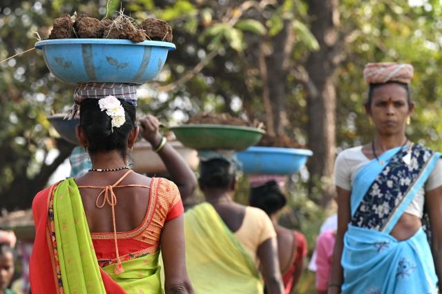 This photograph taken on February 14, 2026 shows wage-labourers under Mahatma Gandhi National Rural Employment Guarantee Act (MGNREGA) toiling a dirt road at a road-construction site at Balapur Dolkarpada village in Maharashtra's Palghar district. India's economy grew at a faster pace than expected in the last quarter of 2025 driven by solid consumer spending, data showed on February 27, using a new framework that calculates economic output more accurately. (Photo by Indranil Mukherjee / AFP)