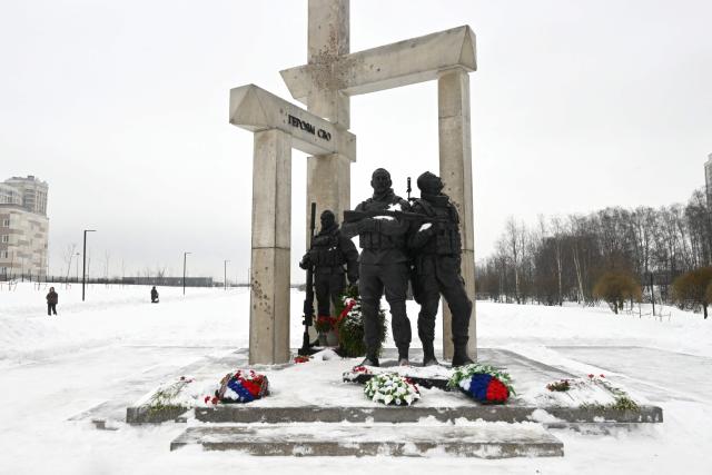 A photo shows the monument "To heroes of the Special Military Operation", erected to pay respect to members of the Russian armed forces involved in the country's military campaign in Ukraine, in the town of Kudrovo, Leningrad region on February 27, 2026, as Russia marks Special Operations Forces Day. (Photo by Olga MALTSEVA / AFP)