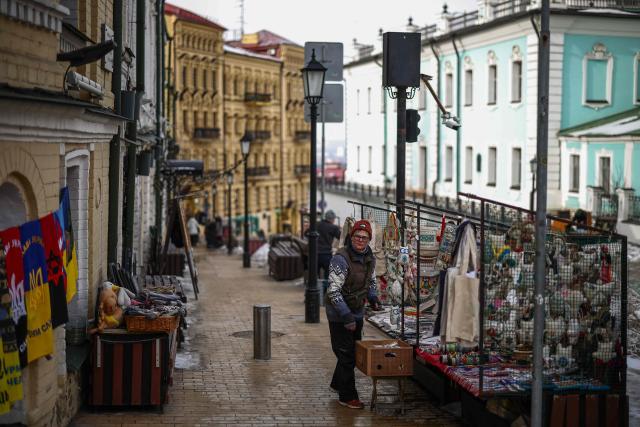 A market vendor works at their stall in central Kyiv on February 27, 2026, amid the Russian invasion of Ukraine. (Photo by HENRY NICHOLLS / AFP)
