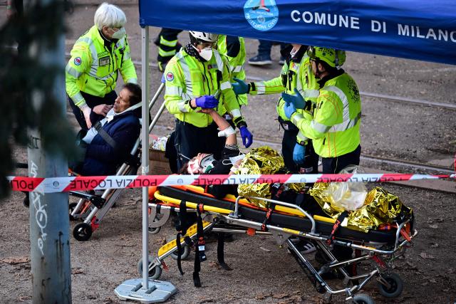EDITORS NOTE: Graphic content / Emergency service teams evacuate victims at the site of a tram derailment in Milan on February 27, 2026. A tram derailed and smashed into a building in Milan on February 27, 2026, killing one person and injuring around 20 others, the police told AFP. (Photo by Piero CRUCIATTI / AFP)