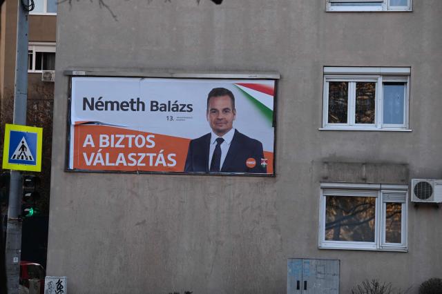 An electoral campaign poster showing Hungary's ruling FIDESZ party spokesperson Balazs Nemeth is seen in one of Budapest's outer districts on February 27, 2026. (Photo by Attila KISBENEDEK / AFP)
