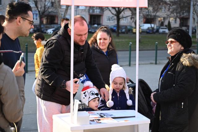 A supporter collects signatures for Hungary's ruling FIDESZ party spokesperson Balazs Nemeth during a campaign in one of Budapest's outer districts on February 27, 2026. (Photo by Attila KISBENEDEK / AFP)