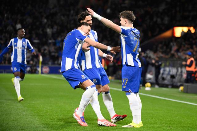 FC Porto's Polish midfielder #77 Oskar Pietuszewski (R) celebrates scoring the opening goal during the Portuguese League football match between FC Porto and FC Arouca at Dragao stadium in Porto, on February 27, 2026. (Photo by Miguel RIOPA / AFP)