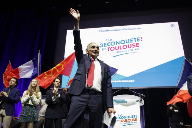 French far-right Reconquete! party leader Eric Zemmour waves to attendees during a campaign meeting of the Reconquete! Toulouse mayoral candidate in Toulouse, southwestern France, on February 27, 2026. French voters head to the polls for municipal elections on March 15 and 22, 2026. (Photo by Valentine CHAPUIS / AFP)
