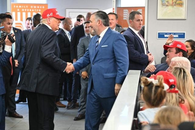 US President Donald Trump shakes hands with US Senator Ted Cruz (R-TX) in a Whataburger restaurant in Corpus Christi, Texas, on February 27, 2026. (Photo by Mandel NGAN / AFP)