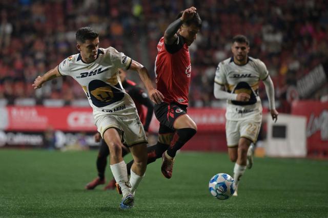 Pumas' midfielder #07 Rodrigo Lopez and Tijuana's Argentine midfielder #27 Domingo Blanco fight for the ball during the Liga MX Clausura football match between Tijuana and Pumas at Caliente stadium in Tijuana, Mexico on February 27, 2026. (Photo by Guillermo Arias / AFP)