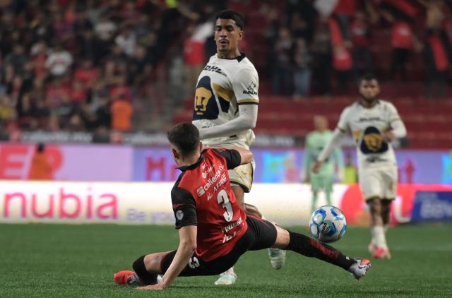 Tijuana's defender #03 Rafael Inzunza and Pumas' defender #215 Angel Azuaje fight for the ball during the Liga MX Clausura football match between Tijuana and Pumas at Caliente stadium in Tijuana, Mexico on February 27, 2026. (Photo by Guillermo Arias / AFP)