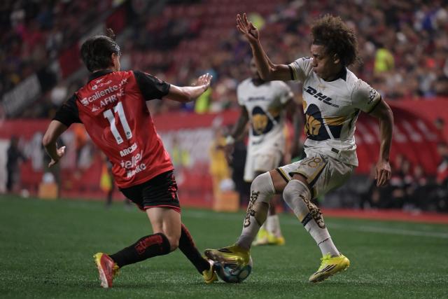 Tijuana's forward #17 Ramiro Arciga and Pumas' Panamanian midfielder #28 Adalberto Carrasquilla fight for the ball during the Liga MX Clausura football match between Tijuana and Pumas at Caliente stadium in Tijuana, Mexico on February 27, 2026. (Photo by Guillermo Arias / AFP)