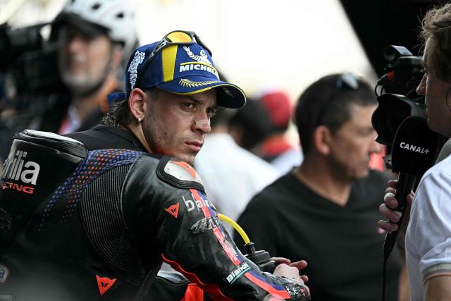 Aprilia Racing's Italian rider Marco Bezzecchi looks on as he celebrates taking pole position in the qualifying session of the MotoGP Thailand Grand Prix at the Buriram International Circuit in Buriram on February 28, 2026. (Photo by Lillian SUWANRUMPHA / AFP)