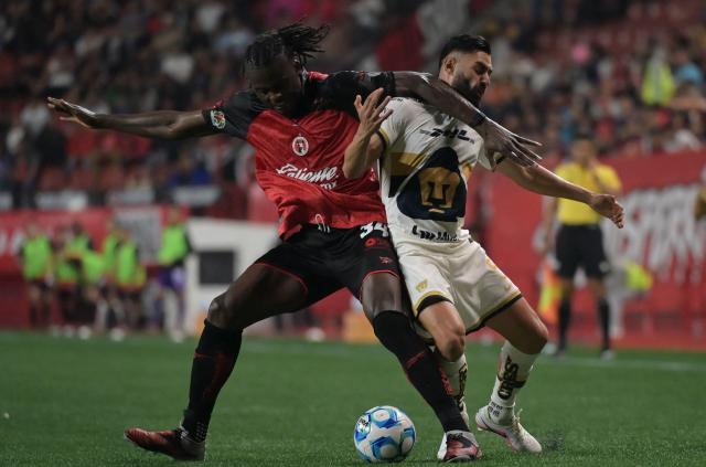 Tijuana's Cameroonian midfielder #34 Frank Boya and Pumas' Spanish defender #05 Ruben Duarte fight for the ball during the Liga MX Clausura football match between Tijuana and Pumas at Caliente stadium in Tijuana, Mexico on February 27, 2026. (Photo by Guillermo Arias / AFP)