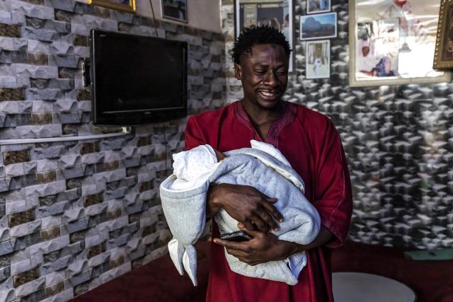 Doudou Sene holds his newborn baby Mohamed at his home in Dakar, on February 27, 2026. What started as small workouts in one of the many outdoor gyms that proliferate in Dakar slowly turned into a passion for Doudou Sene. People kept telling him that he had potential in the world of fitness, and in 2019 he began to train seriously. In 2021, he participated in his first powerlifting competition in Dakar and finished first in the under?83 kg category. Soon after, he traveled to The Gambia for another competition, where he finished third. After succeeding as a powerlifter, he decided to switch to bodybuilding, a little?known sport in Senegal with few role models, such as Sidy Pouye, who has managed to build a successful career abroad as a bodybuilder. People dont know much about the sport, but that doesnt stop Doudou from following his passion. During the holy month of Ramadan, training and maintaining a proper diet become challenging. Doudou normally eats five to six meals a day to maintain his gains, but during Ramadan this is reduced to two or three. He prefers to train at the gym where he works right before breaking the fast, and then stays late to help clients with their workouts. Family and religion are his driving forces as he continues pushing himself, even during Ramadan, to achieve his goal of making a living as a bodybuilder and providing for his family. (Photo by PATRICK MEINHARDT / AFP)