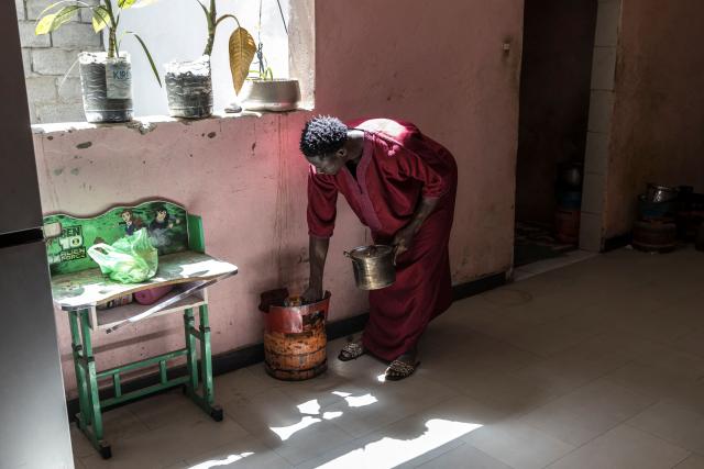 Doudou Sene heats water at his home as he gets ready for the Friday prayer during the holy month of Ramadan in Dakar, on February 27, 2026. What started as small workouts in one of the many outdoor gyms that proliferate in Dakar slowly turned into a passion for Doudou Sene. People kept telling him that he had potential in the world of fitness, and in 2019 he began to train seriously. In 2021, he participated in his first powerlifting competition in Dakar and finished first in the under?83 kg category. Soon after, he traveled to The Gambia for another competition, where he finished third. After succeeding as a powerlifter, he decided to switch to bodybuilding, a little?known sport in Senegal with few role models, such as Sidy Pouye, who has managed to build a successful career abroad as a bodybuilder. People dont know much about the sport, but that doesnt stop Doudou from following his passion. During the holy month of Ramadan, training and maintaining a proper diet become challenging. Doudou normally eats five to six meals a day to maintain his gains, but during Ramadan this is reduced to two or three. He prefers to train at the gym where he works right before breaking the fast, and then stays late to help clients with their workouts. Family and religion are his driving forces as he continues pushing himself, even during Ramadan, to achieve his goal of making a living as a bodybuilder and providing for his family. (Photo by PATRICK MEINHARDT / AFP)