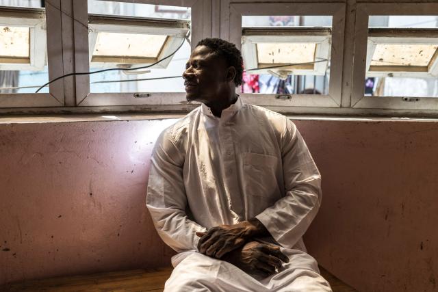 Doudou Sene poses for a portrait at his home after the Friday prayer during the holy month of Ramadan in Dakar, on February 27, 2026. What started as small workouts in one of the many outdoor gyms that proliferate in Dakar slowly turned into a passion for Doudou Sene. People kept telling him that he had potential in the world of fitness, and in 2019 he began to train seriously. In 2021, he participated in his first powerlifting competition in Dakar and finished first in the under?83 kg category. Soon after, he traveled to The Gambia for another competition, where he finished third. After succeeding as a powerlifter, he decided to switch to bodybuilding, a little?known sport in Senegal with few role models, such as Sidy Pouye, who has managed to build a successful career abroad as a bodybuilder. People dont know much about the sport, but that doesnt stop Doudou from following his passion. During the holy month of Ramadan, training and maintaining a proper diet become challenging. Doudou normally eats five to six meals a day to maintain his gains, but during Ramadan this is reduced to two or three. He prefers to train at the gym where he works right before breaking the fast, and then stays late to help clients with their workouts. Family and religion are his driving forces as he continues pushing himself, even during Ramadan, to achieve his goal of making a living as a bodybuilder and providing for his family. (Photo by PATRICK MEINHARDT / AFP)