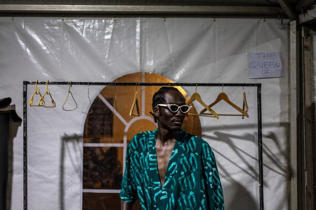 A model poses for a photo backstage before a fashion show during the Togo International Festival of Fashion (FIMO) at the Onomo Hotel in Lome on February 27, 2026. (Photo by OLYMPIA DE MAISMONT / AFP)