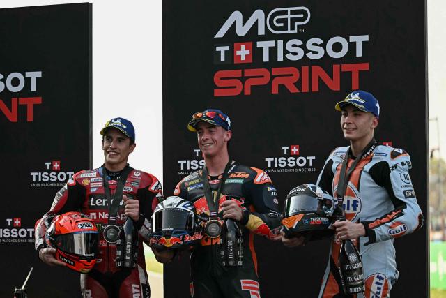 Sprint race winner Red Bull KTM Factory Racing's Spanish rider Pedro Acosta (C) celebrates with second-placed Ducati Lenovo Team's Spanish rider Marc Marquez (L) and third-placed Trackhouse MotoGP's Spanish rider Raul Fernandez (R) after the sprint race at the MotoGP Thailand Grand Prix at the Buriram International Circuit in Buriram on February 28, 2026. (Photo by Lillian SUWANRUMPHA / AFP)