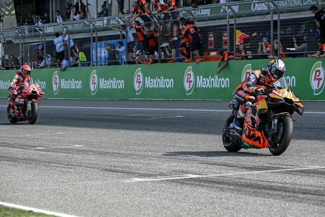 Red Bull KTM Factory Racing's Spanish rider Pedro Acosta (R) rides in front of Ducati Lenovo Team's Spanish rider Marc Marquez to win the sprint race of the MotoGP Thailand Grand Prix at the Buriram International Circuit in Buriram on February 28, 2026. (Photo by Lillian SUWANRUMPHA / AFP)