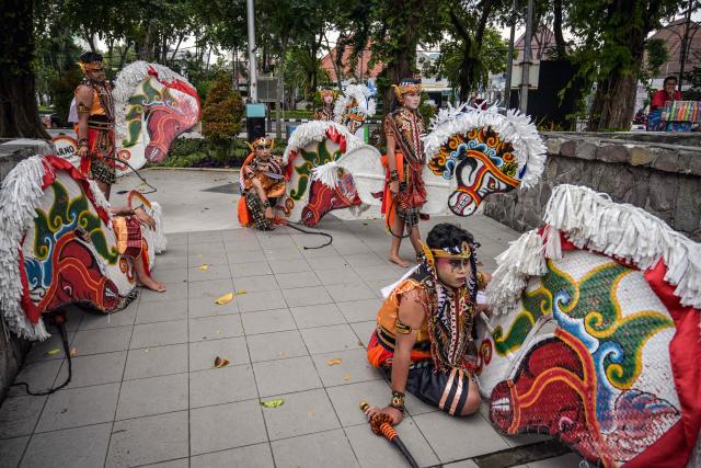 Dancers from a traditional Javanese performance arts group called the Jaranan Jagad Trenggono prepare to perform Jaranan (horse dance) for Muslims who gathered to watch the show at Bungkul Park as they wait before breaking their fast during the holy fasting month of Ramadan in Surabaya, Indonesia's East Java province on February 28, 2026. (Photo by JUNI KRISWANTO / AFP)