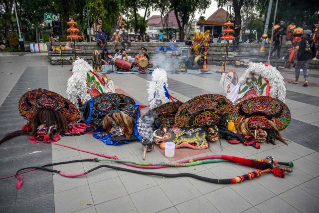 Masks and instruments are seen before dancers from a traditional Javanese performance arts group called the Jaranan Jagad Trenggono perform Jaranan (horse dance) for Muslims who gathered to watch the show at Bungkul Park as they wait before breaking their fast during the holy fasting month of Ramadan in Surabaya, Indonesia's East Java province on February 28, 2026. (Photo by JUNI KRISWANTO / AFP)