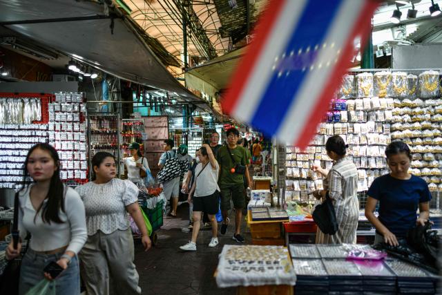 Visitors walk through an alley at Sampheng Market in Bangkok on February 28, 2026. (Photo by Amaury PAUL / AFP)