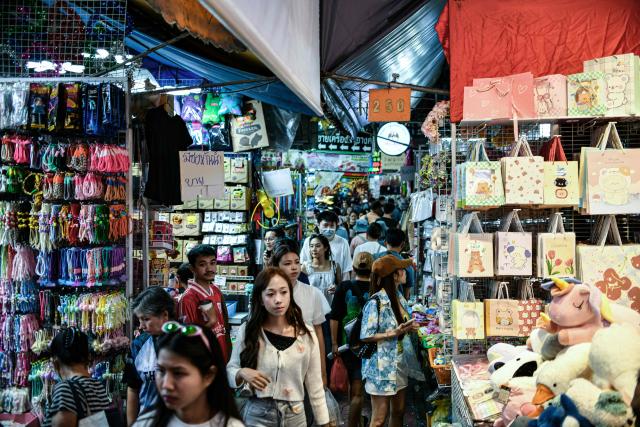 Visitors walk through an alley at Sampheng Market in Bangkok on February 28, 2026. (Photo by Amaury PAUL / AFP)