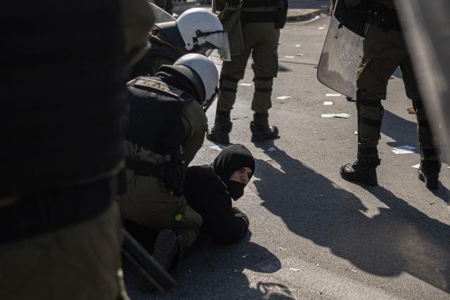 Riot police officers detain a protester during a demonstration outside the Greek parliament, in Athens, on February 28, 2026, marking the third anniversary of the Tempi train crash that killed 57 people in 2023. Thousands of people across Greece will demonstrate on February 28, 2026, in solidarity with victims of the country's worst train tragedy, which claimed 57 lives in 2023 and rattled the government of Prime Minister Kyriakos Mitsotakis. (Photo by Angelos TZORTZINIS / AFP)