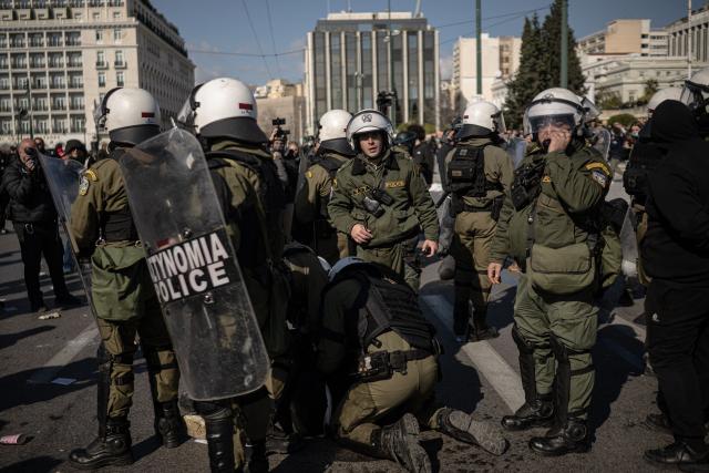 Riot police officers detain a protester during a demonstration outside the Greek parliament, in Athens, on February 28, 2026, marking the third anniversary of the Tempi train crash that killed 57 people in 2023. Thousands of people across Greece will demonstrate on February 28, 2026, in solidarity with victims of the country's worst train tragedy, which claimed 57 lives in 2023 and rattled the government of Prime Minister Kyriakos Mitsotakis. (Photo by Angelos TZORTZINIS / AFP)