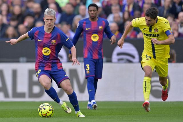 Barcelona's Spanish midfielder #20 Daniel Olmo (L) and Villarreal's Spanish midfielder #14 Santi Comesana fight for the ball during the Spanish league football match between FC Barcelona and Villarreal CF at Camp Nou Stadium in Barcelona on February 28, 2026. (Photo by MANAURE QUINTERO / AFP)