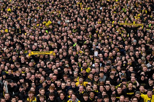 Dortmund fans take part in the fan march to the stadium for the German first division Bundesliga football match between BVB Borussia Dortmund and FC Bayern Munich in Dortmund, western Germany, on February 28, 2026. (Photo by INA FASSBENDER / AFP) / DFL REGULATIONS PROHIBIT ANY USE OF PHOTOGRAPHS AS IMAGE SEQUENCES AND/OR QUASI-VIDEO