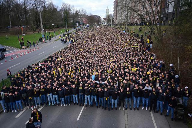 Dortmund fans take part in the fan march to the stadium for the German first division Bundesliga football match between BVB Borussia Dortmund and FC Bayern Munich in Dortmund, western Germany, on February 28, 2026. (Photo by INA FASSBENDER / AFP) / DFL REGULATIONS PROHIBIT ANY USE OF PHOTOGRAPHS AS IMAGE SEQUENCES AND/OR QUASI-VIDEO