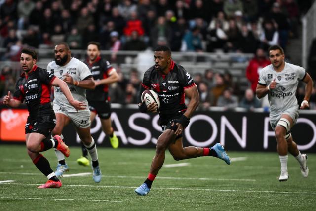 Lyon’s Fidjian wing #11 Jiuta Wainiqolo (C) runs with the ball during the French Top14 rugby union match between Lyon Olympique Universitaire Rugby and RC Toulon at the Gerland Stadium in Lyon, central-eastern France on February 28, 2026. (Photo by ARNAUD FINISTRE / AFP)