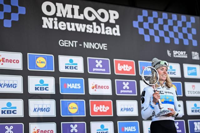 FDJ United's Dutch rider Demi Vollering celebrates on the podium with her trophy after winning the 81st edition of the women's 'Omloop Het Nieuwsblad' UCI World Tour one-day cycling race, the opening race of the Flemish one-day classics season, 207,6 km from Gent to Ninove, in Ninove on February 28, 2026. (Photo by MAARTEN STRAETEMANS / Belga / AFP) / Belgium OUT