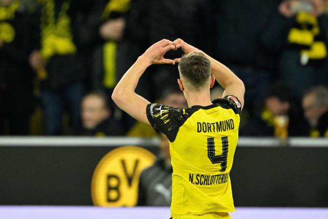 Dortmund's German defender #04 Nico Schlotterbeck celebrates scoring the opening goal in front of their fans during the German first division Bundesliga football match between BVB Borussia Dortmund and FC Bayern Munich in Dortmund, western Germany, on February 28, 2026. (Photo by INA FASSBENDER / AFP) / DFL REGULATIONS PROHIBIT ANY USE OF PHOTOGRAPHS AS IMAGE SEQUENCES AND/OR QUASI-VIDEO