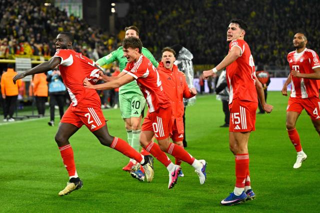 Bayern Munich players celebrate with thier fans after the German first division Bundesliga football match between BVB Borussia Dortmund and FC Bayern Munich in Dortmund, western Germany, on February 28, 2026. (Photo by INA FASSBENDER / AFP) / DFL REGULATIONS PROHIBIT ANY USE OF PHOTOGRAPHS AS IMAGE SEQUENCES AND/OR QUASI-VIDEO