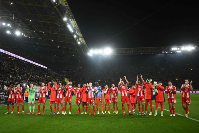 Bayern Munich players celebrate with thier fans after the German first division Bundesliga football match between BVB Borussia Dortmund and FC Bayern Munich in Dortmund, western Germany, on February 28, 2026. (Photo by INA FASSBENDER / AFP) / DFL REGULATIONS PROHIBIT ANY USE OF PHOTOGRAPHS AS IMAGE SEQUENCES AND/OR QUASI-VIDEO