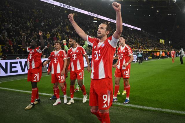 Bayern Munich players including Bayern Munich's English forward #09 Harry Kane celebrate with their fans after the German first division Bundesliga football match between BVB Borussia Dortmund and FC Bayern Munich in Dortmund, western Germany, on February 28, 2026. (Photo by INA FASSBENDER / AFP) / DFL REGULATIONS PROHIBIT ANY USE OF PHOTOGRAPHS AS IMAGE SEQUENCES AND/OR QUASI-VIDEO