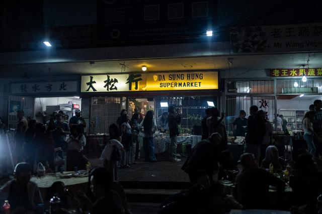 A vendor grills food at a stall during the celebrations of the Chinese New Year, marking the beginning of the Year of the Fire Horse in Cyrildene, Johannesburg on February 28, 2026. (Photo by ILARIA FINIZIO / AFP)