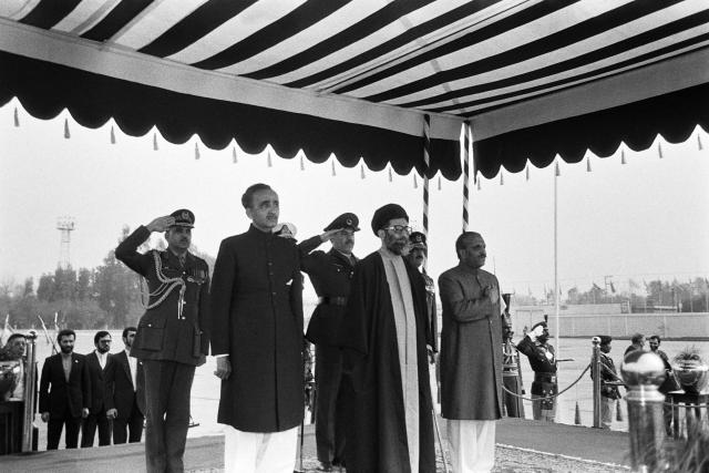 (FILES) President of the Islamic Republic of Iran Ayatollah Ali Khamenei (C), Pakistani President General Muhammad Zia-ul-Haq (R) and Prime Minister Mohammad Khan Junejo (2nd L), listen to the national anthems on January 13, 1986 upon Khamenei's arrival in Islamabad, Pakistan, where he is to sign an India-Pakistan trade agreement. US President Donald Trump announced on February 28, 2026, that Iran's supreme leader Ali Khamenei is confirmed dead. The United States and Israel launched strikes against Iran on February 28, with Israel's public broadcaster reporting that the Iranian supreme leader had been targeted, as the Islamic republic retaliated with barrages of missiles at Gulf states and Israel. (Photo by Ahmed ASHFAQ / AFP)
