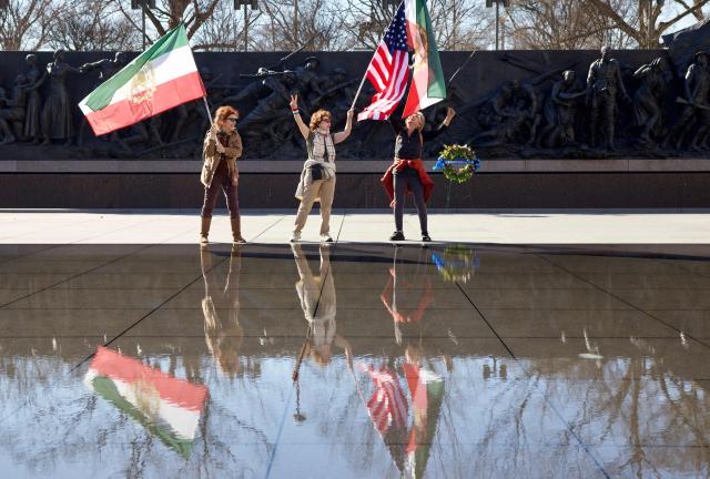 People cheer as they wave Iranian and US flags during a rally expressing support for US and Israeli military action against Iran’s Islamic Republic government on February 28, 2026 in Washington, DC. The US and Israel launched an attack of unprecedented scale against Iran on Saturday, reportedly killing more than 200 people, with Tehran launching a retaliatory missile barrage that sent people running for cover across the Middle East. (Photo by Amid FARAHI / AFP) / “The erroneous mention[s] appearing in the metadata of this photo by Amid FARAHI has been modified in AFP systems in the following manner: [February 28] instead of [February 29]. Please immediately remove the erroneous mention[s] from all your online services and delete it (them) from your servers. If you have been authorized by AFP to distribute it (them) to third parties, please ensure that the same actions are carried out by them. Failure to promptly comply with these instructions will entail liability on your part for any continued or post notification usage. Therefore we thank you very much for all your attention and prompt action. We are sorry for the inconvenience this notification may cause and remain at your disposal for any further information you may require.”
