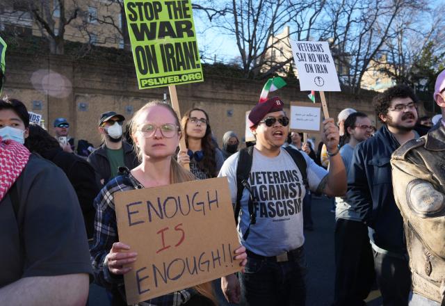 Protestors hold signs condemning the war on Iran during a protest outside the State Department in Washington, DC, on February 28, 2026. The United States and Israel launched what the latter called a "decisive and unprecedented" campaign against Iran, which retaliated with a barrage of missiles that sent residents running for cover on Saturday in cities across the Middle East. (Photo by Ken Cedeno / AFP)