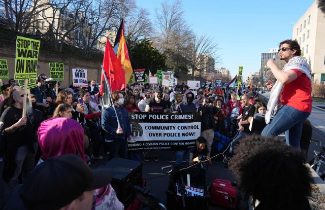 Protestors wave flags and hold signs condemning the war on Iran during a protest outside the State Department in Washington, DC, on February 28, 2026. The United States and Israel launched what the latter called a "decisive and unprecedented" campaign against Iran, which retaliated with a barrage of missiles that sent residents running for cover on Saturday in cities across the Middle East. (Photo by Ken Cedeno / AFP)