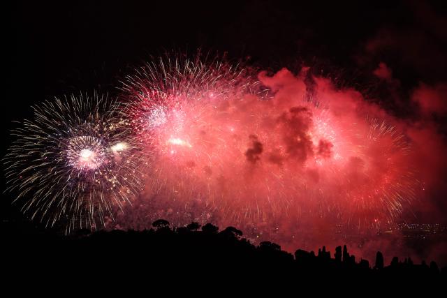 This photograph shows fireworks exploding over the "Baie des anges" to mark the end of the Nice Carnival, in Nice, southeastern France, on February 28, 2026. (Photo by Valery HACHE / AFP)